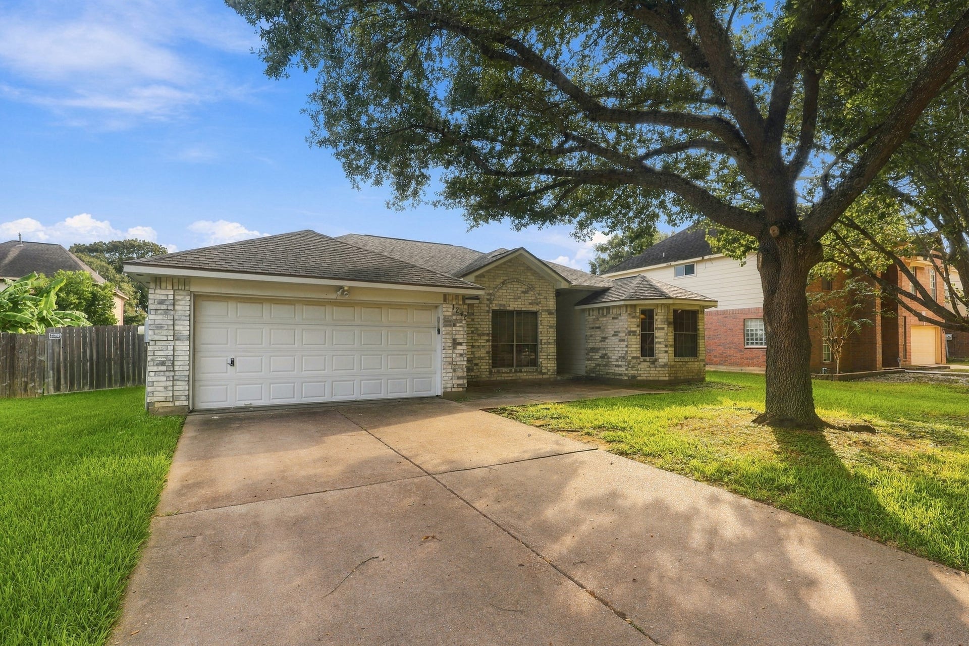 1242 Hunter Wood Drive, League City, TX 77573 Another view of the inviting exterior, spacious driveway and two-car garage.