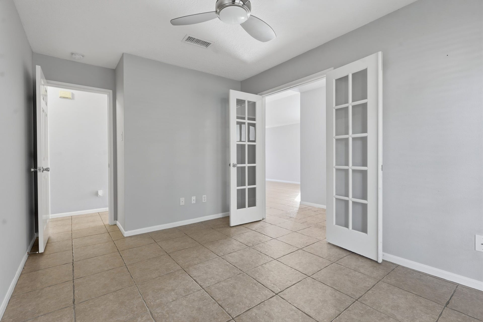 1242 Hunter Wood Drive, League City, TX 77573 Versatile bedroom with double French doors, ideal for a home office, study or flex space.