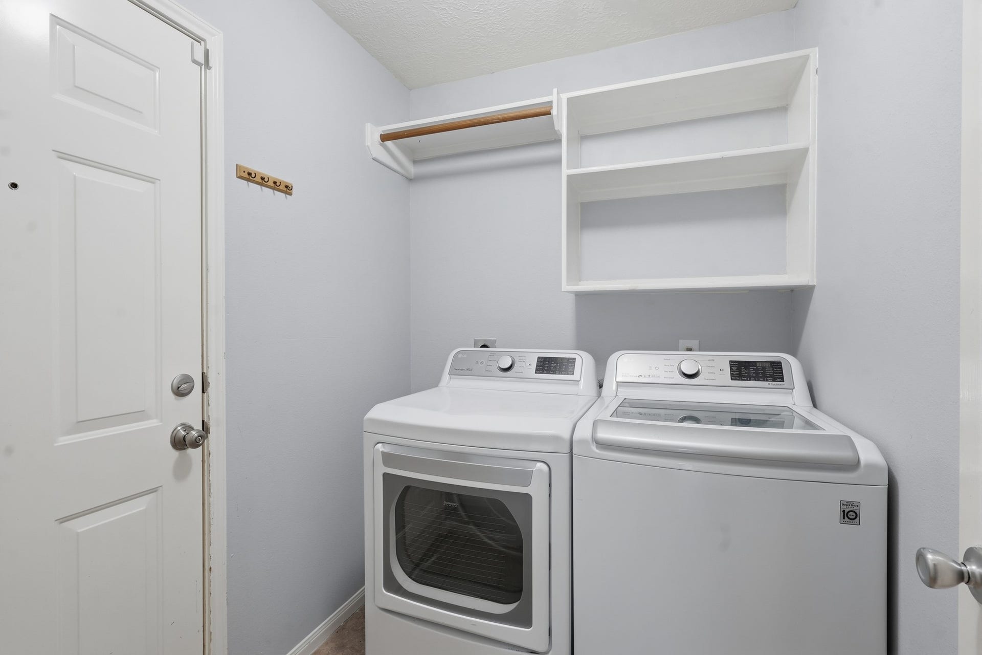1242 Hunter Wood Drive, League City, TX 77573 Dedicated laundry room with built-in shelving for added storage and organization.
