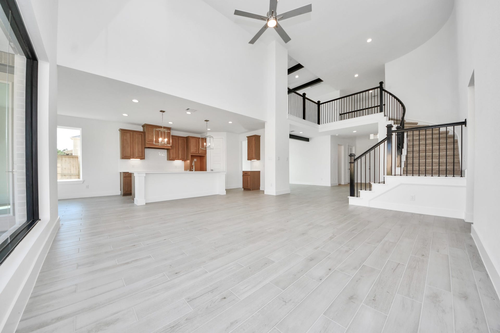 2052 Thimbleberry Lane, Magnolia, TX 77355 Gather the family and guests together in your lovely living room! Featuring soaring high ceilings, recessed lighting, ceiling fan, custom paint, gorgeous floors, and large windows that provide plenty of natural lighting throughout the day.