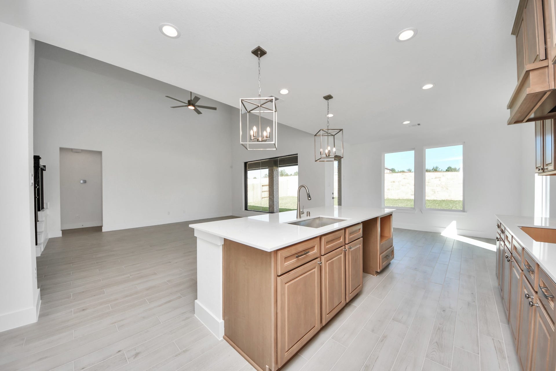 2052 Thimbleberry Lane, Magnolia, TX 77355 Step into a dream realized with this generously spacious kitchen! A massive granite island takes center stage, complemented by high ceilings and soft-close cabinets. The granite countertops, stainless steel appliances, sleek tile backsplash, and recessed lighting complete the elegant design.
