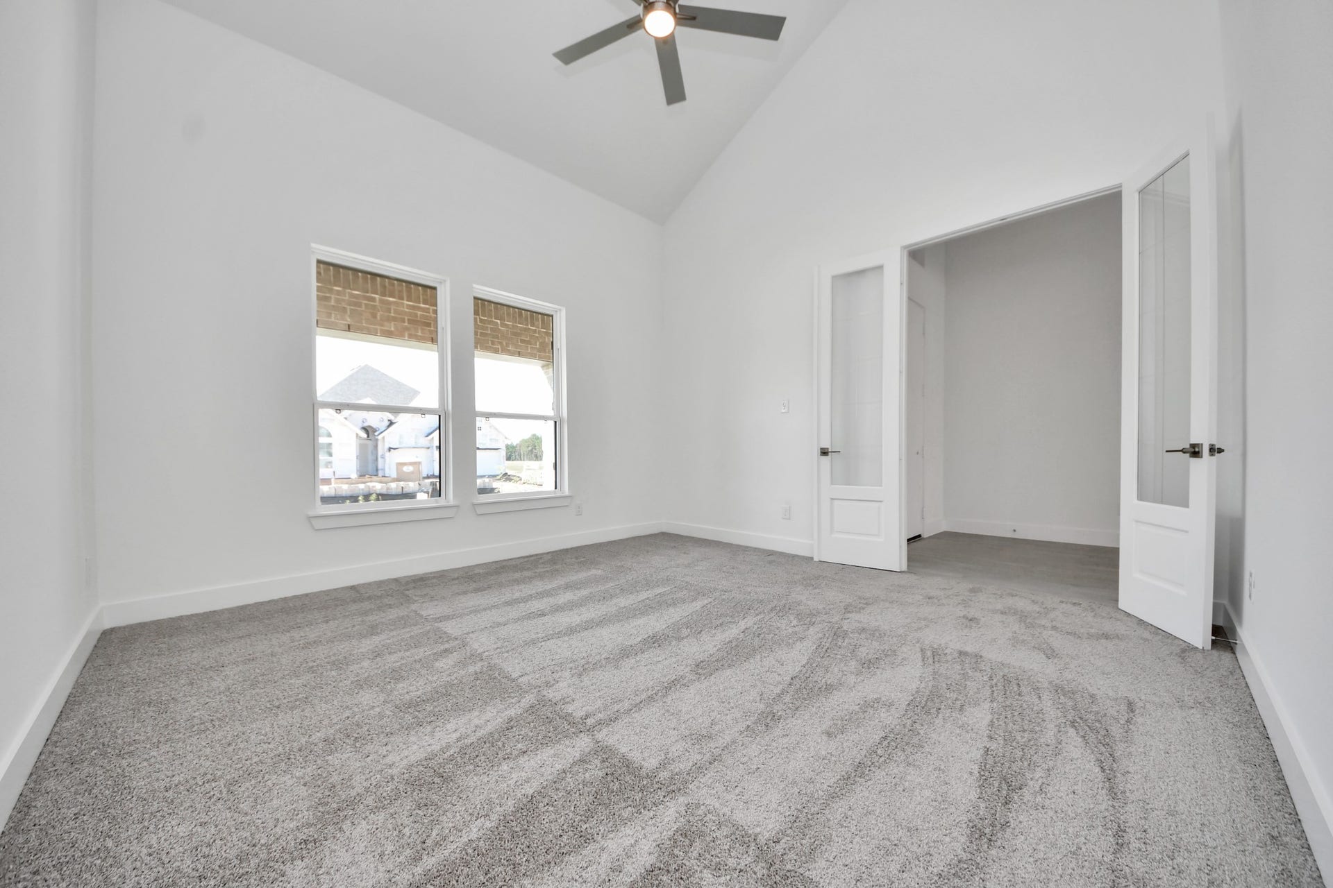 2052 Thimbleberry Lane, Magnolia, TX 77355 Experience the perfect blend of sophistication and warmth in this home office, flooded with natural light from expansive windows and French doors.