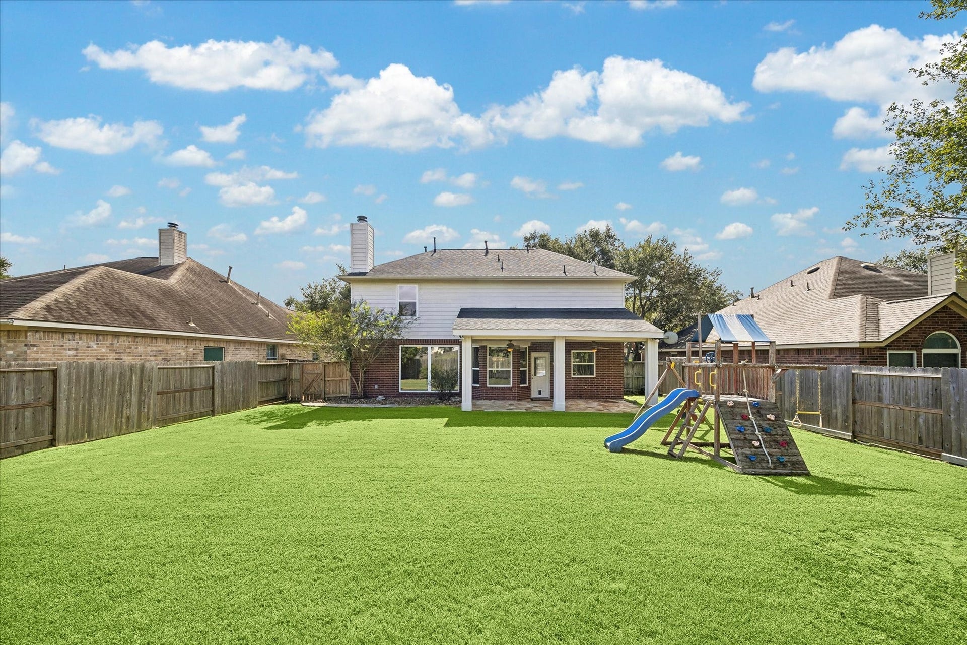 7614 BROKEN OAK LANE, Sugar Land, TX 77479 A wide view captures the generous FENCED BACKYARD and covered entertaining space.