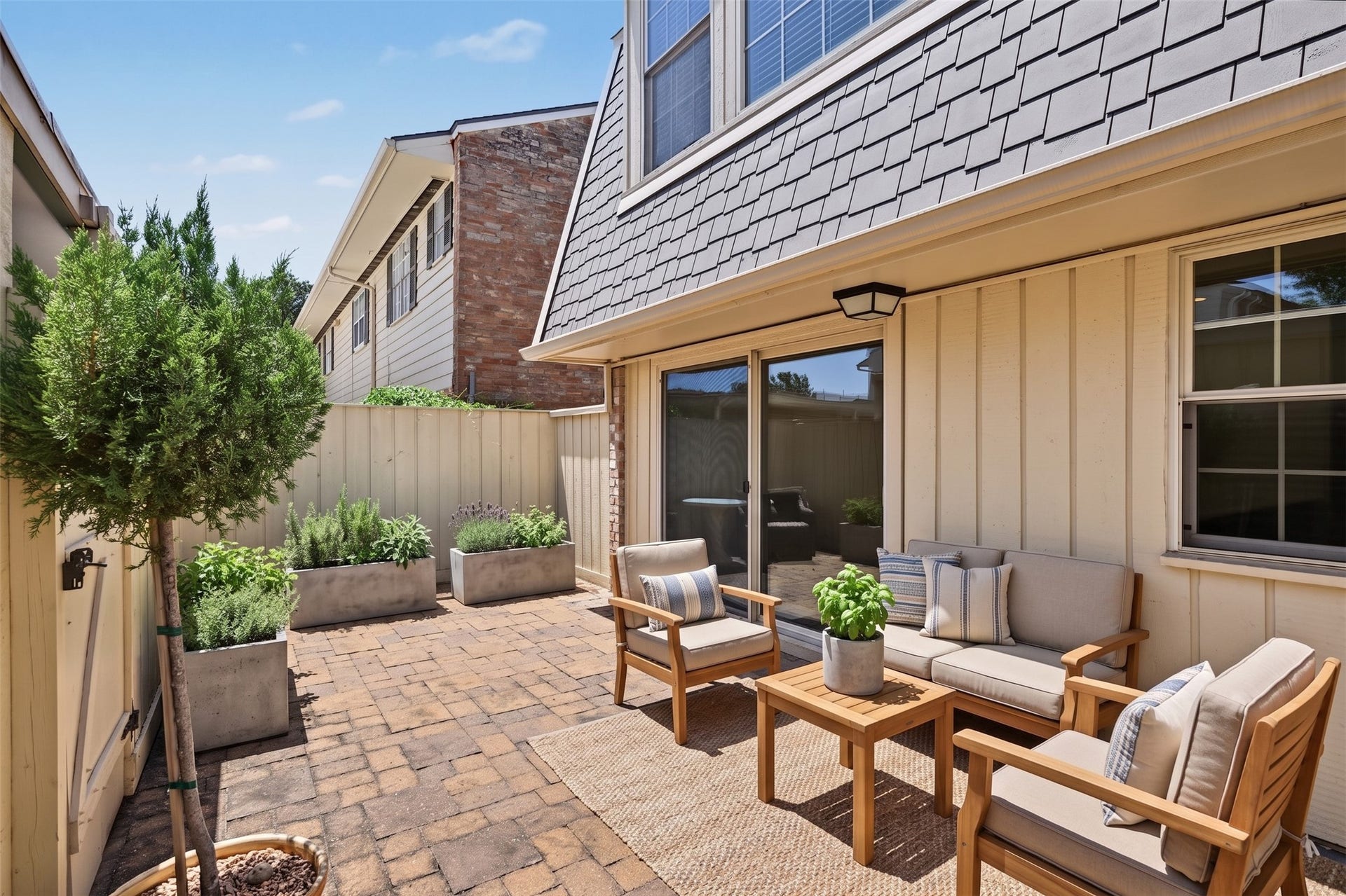 5879 Valley Forge Drive, #107, Houston, TX 77057 Your private patio has ample space for both lounging and dining. This photo is virtually furnished.
