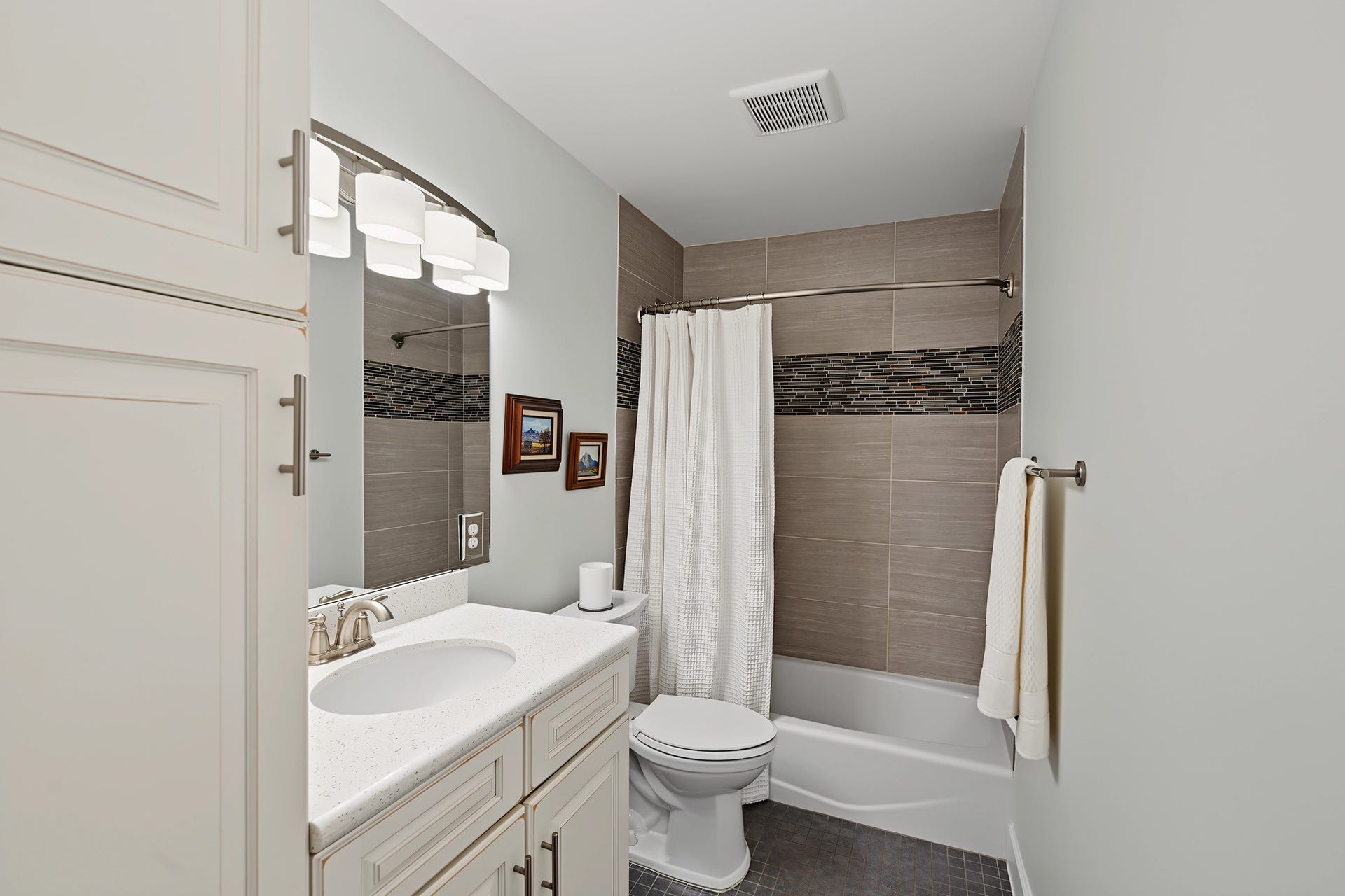 5879 Valley Forge Drive, #107, Houston, TX 77057 The en-suite bath for primary 2 has modern tile, quartz counter, and linen storage.