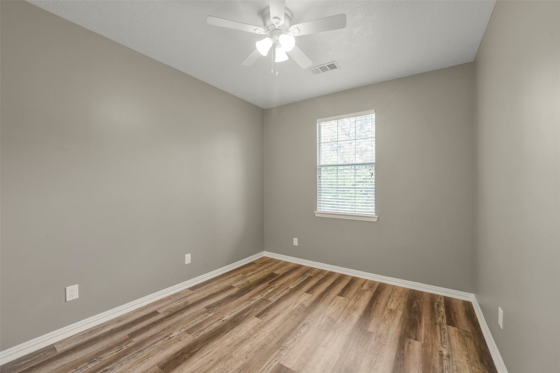 13023 Norstrum Falls Court, Cypress, TX 77429 A spacious secondary bedroom upstairs features great proportions, a closet, and bright windows.