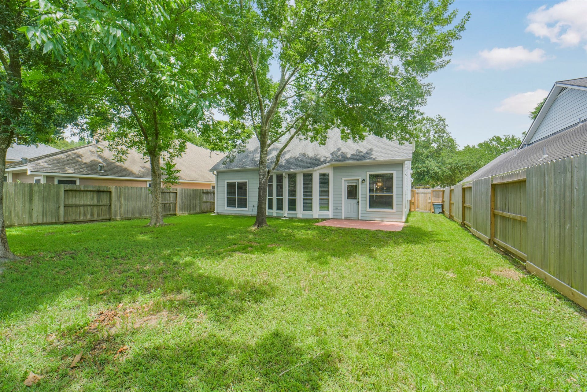 13023 Norstrum Falls Court, Cypress, TX 77429 An alternate view of the spacious backyard showcases the lush green lawn and great privacy, perfect for outdoor activities.