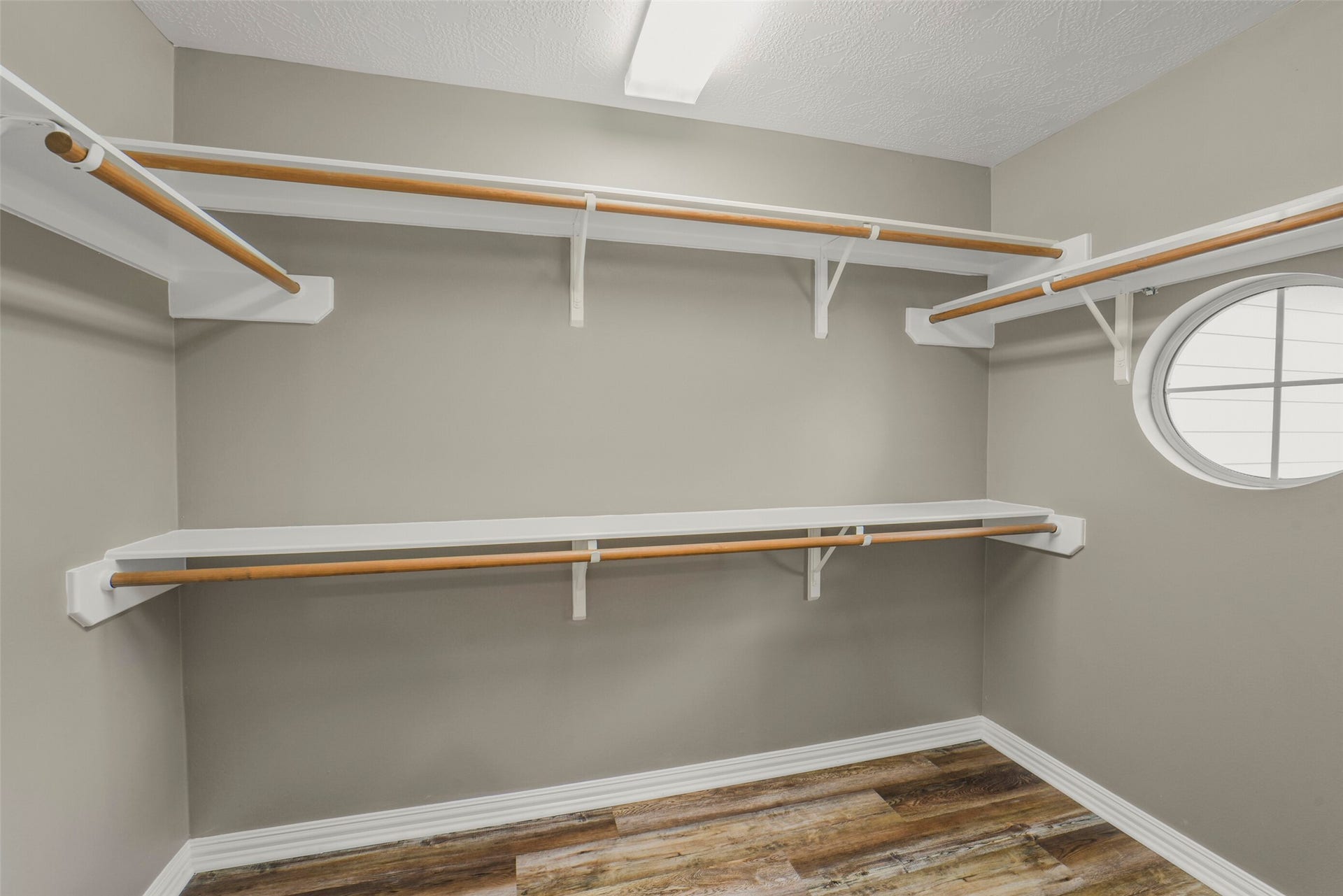 13023 Norstrum Falls Court, Cypress, TX 77429 The massive primary walk-in closet boasts extensive built-in shelving and ample storage for a complete wardrobe.