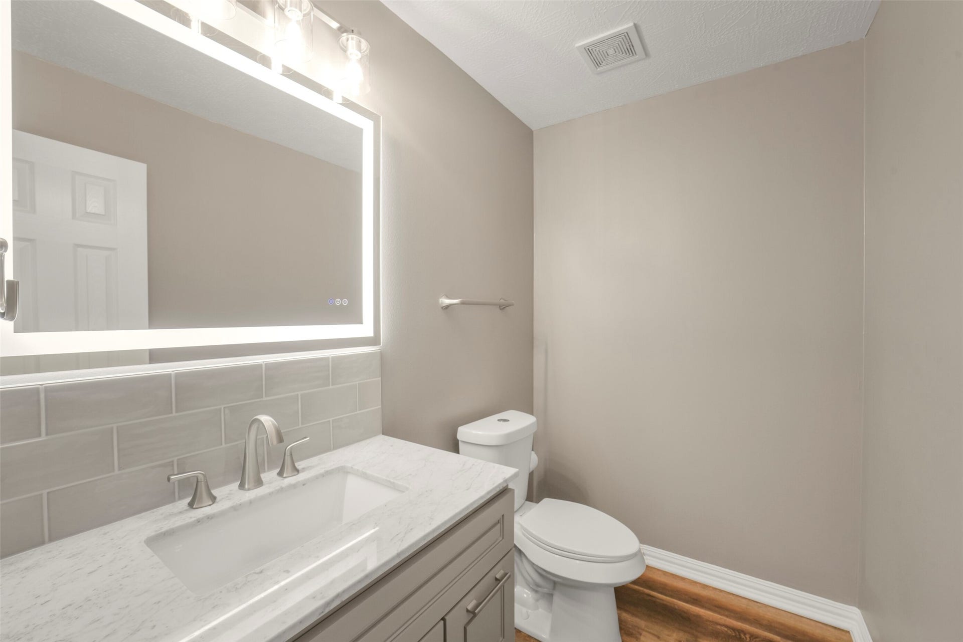 13023 Norstrum Falls Court, Cypress, TX 77429 A beautifully appointed half bath downstairs offers convenience for guests and features modern fixtures.