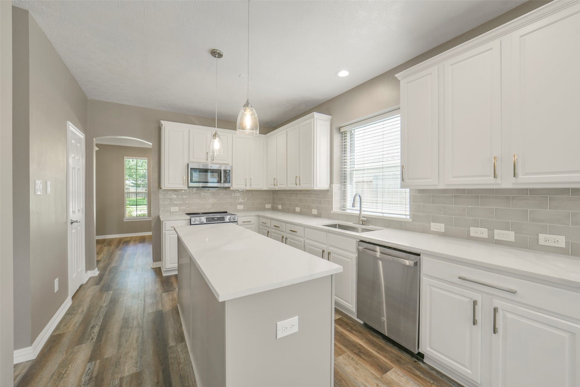 13023 Norstrum Falls Court, Cypress, TX 77429 The gourmet kitchen features stainless steel appliances, a large island perfect for prepping, and seamless connectivity to the formal dining room.