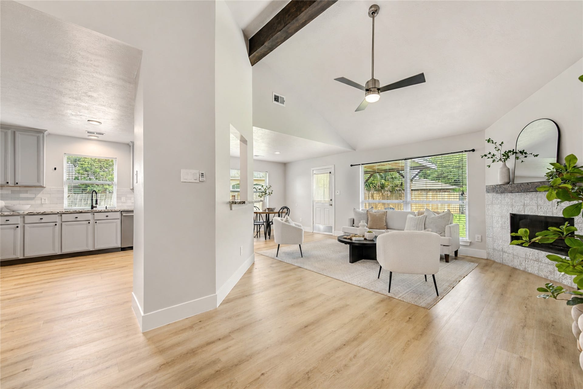 4931 Lake Catherine Court, Richmond, TX 77407 Wooden beam at ceiling and updated fireplace style adds to modern barn house look