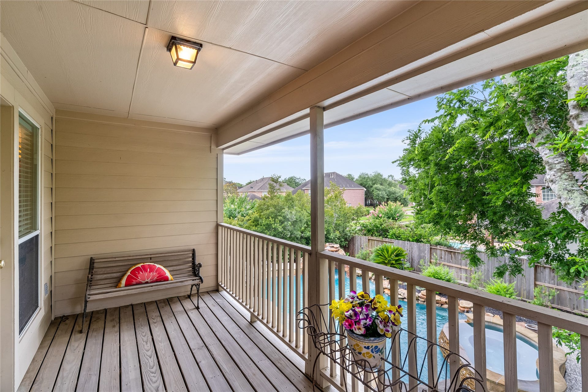 7914 Chianti Court, Sugar Land, TX 77479 Private covered balcony with wood decking overlooks the backyard, offering a peaceful outdoor retreat.