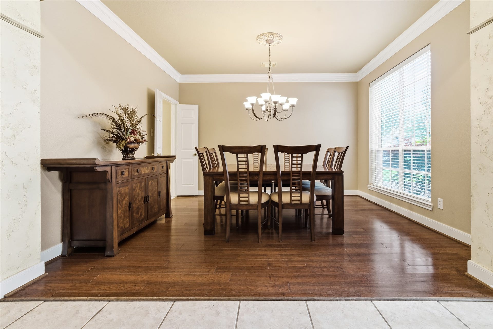 7914 Chianti Court, Sugar Land, TX 77479 Formal dining room offers ample space for gatherings, featuring warm wood floors, classic crown molding, and a centrally placed chandelier.
