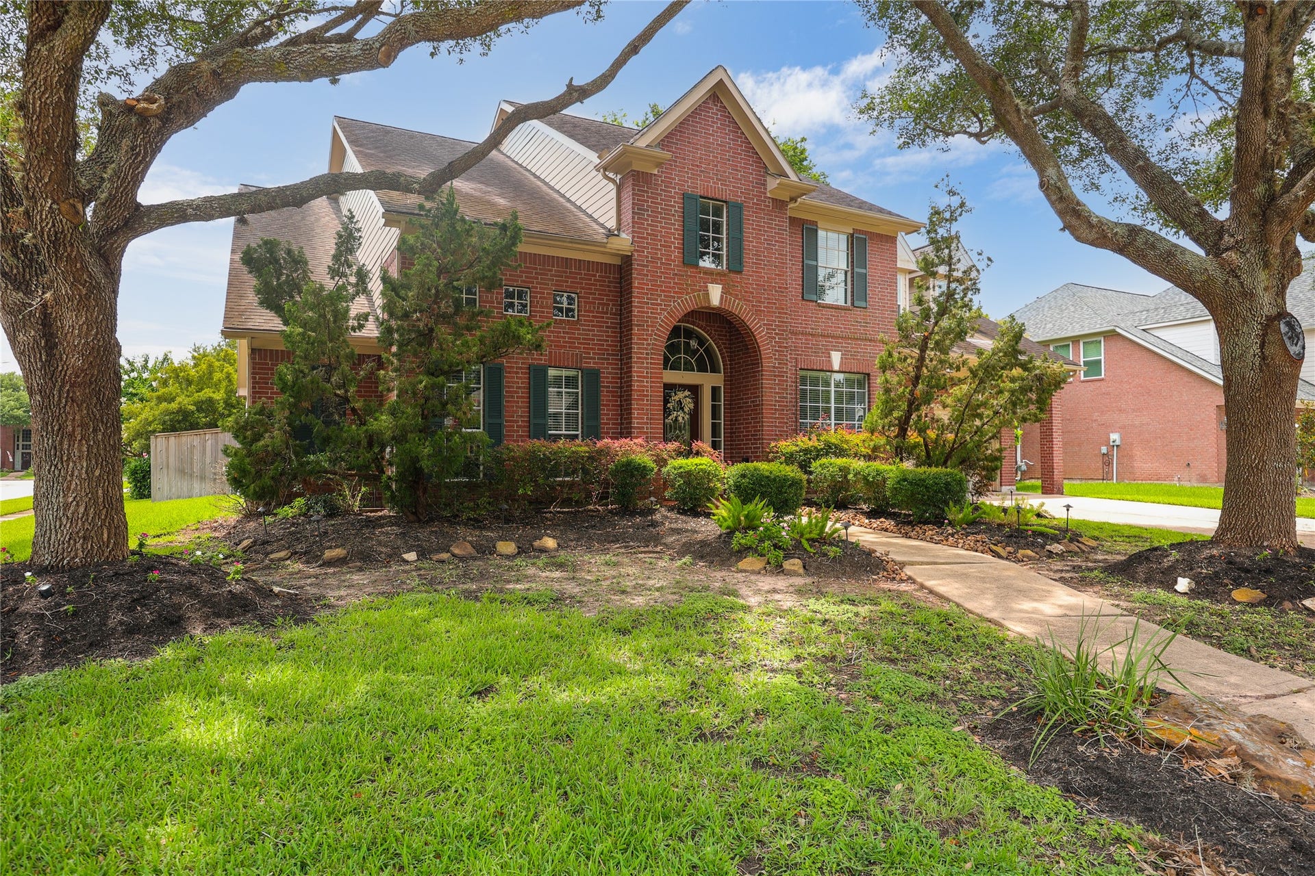 7914 Chianti Court, Sugar Land, TX 77479 Situated on a desirable corner lot with expansive green space and mature trees, offering added curb appeal and presence.