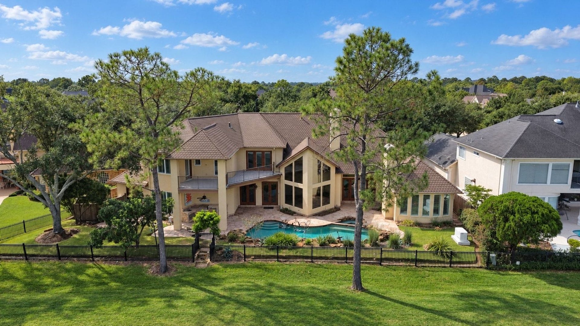 5206 Cedar Bend Creek, Houston, TX 77041 This image highlights the stunning back view of the property, showcasing the expansive, well-maintained backyard alongside the meticulously curated professional landscaping that enhances the overall curb appeal and charm of this lovely home!