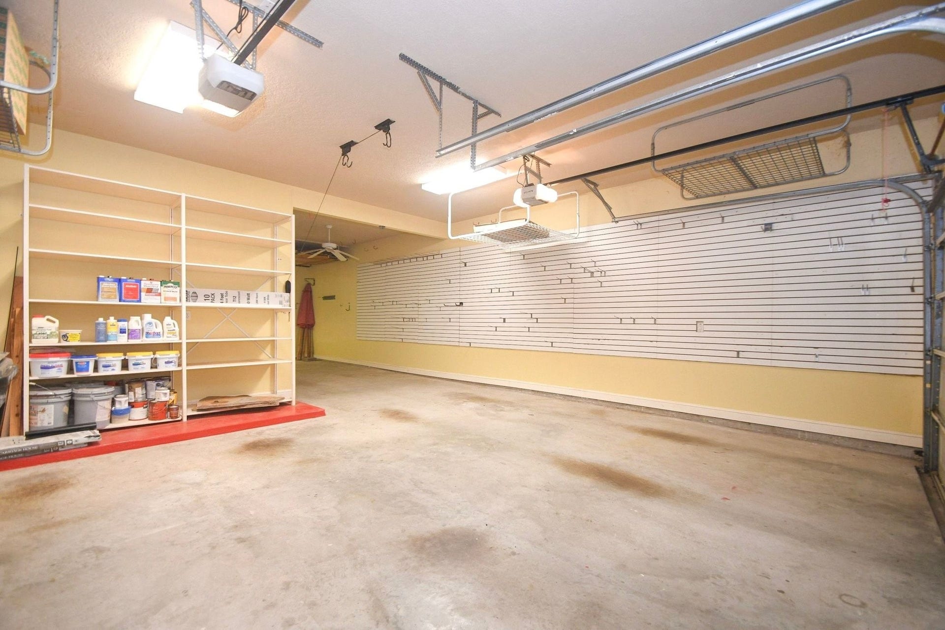 5206 Cedar Bend Creek, Houston, TX 77041 Spacious 3-car garage featuring extensive custom pegboard storage organization, ideal for workshop projects and equipment management!
