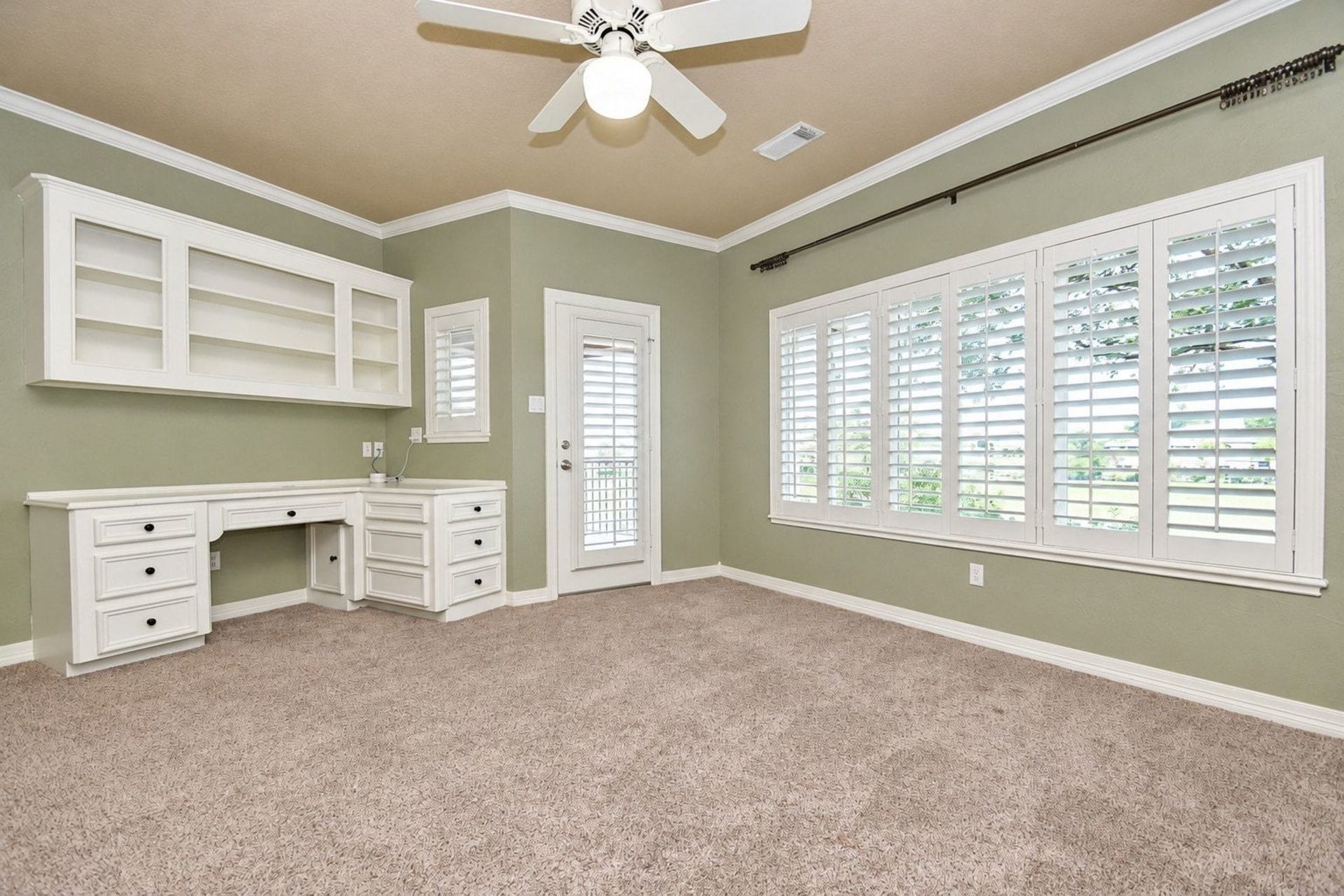 5206 Cedar Bend Creek, Houston, TX 77041 This expansive and light-filled upstairs bedroom features floor-to-ceiling windows that bathe the space in natural sunlight. The room is further enhanced by sophisticated custom built-in cabinetry offering ample storage and elegant display space, while a sliding glass door provides seamless, direct access to a private, peaceful patio perfect for morning coffee or evening relaxation!