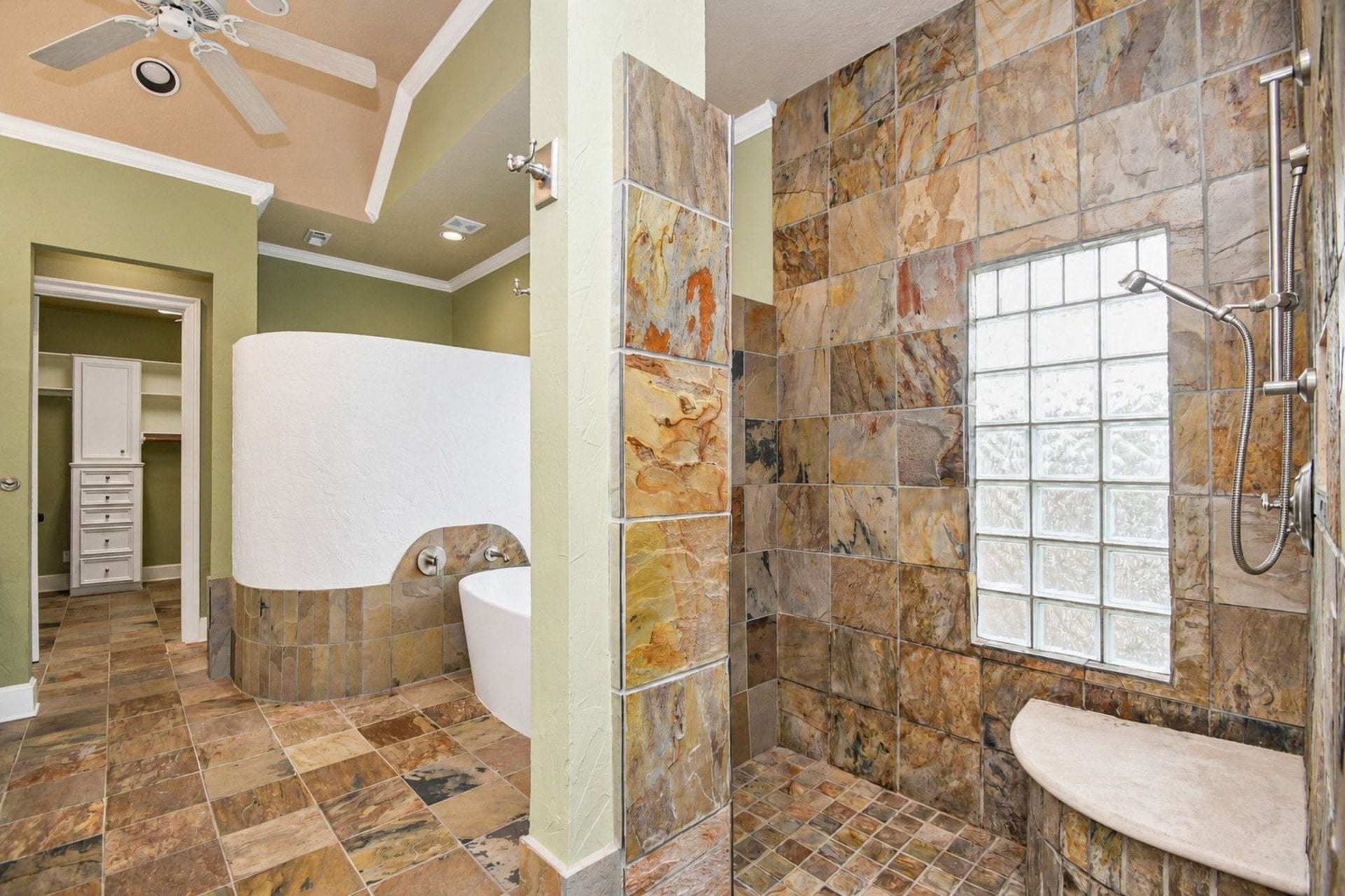 5206 Cedar Bend Creek, Houston, TX 77041 Step into the primary ensuite, a true sanctuary designed for ultimate relaxation and refined comfort. This master bath features sophisticated block glass windows that elegantly invite an abundance of natural light while ensuring complete privacy from the exterior!