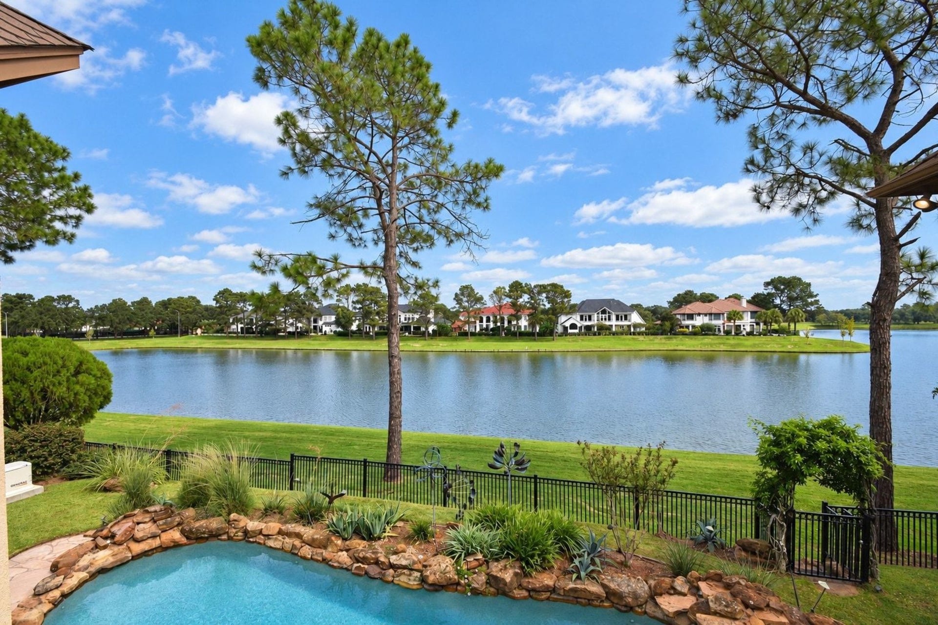 5206 Cedar Bend Creek, Houston, TX 77041 Views from your back yard of the lake and pool! This stunning outdoor oasis features expansive water views and a pristine swimming pool, perfect for entertaining or relaxing in your own private sanctuary. The seamless integration of the pool area with the natural beauty of the lake creates a serene and picturesque backdrop for everyday living!