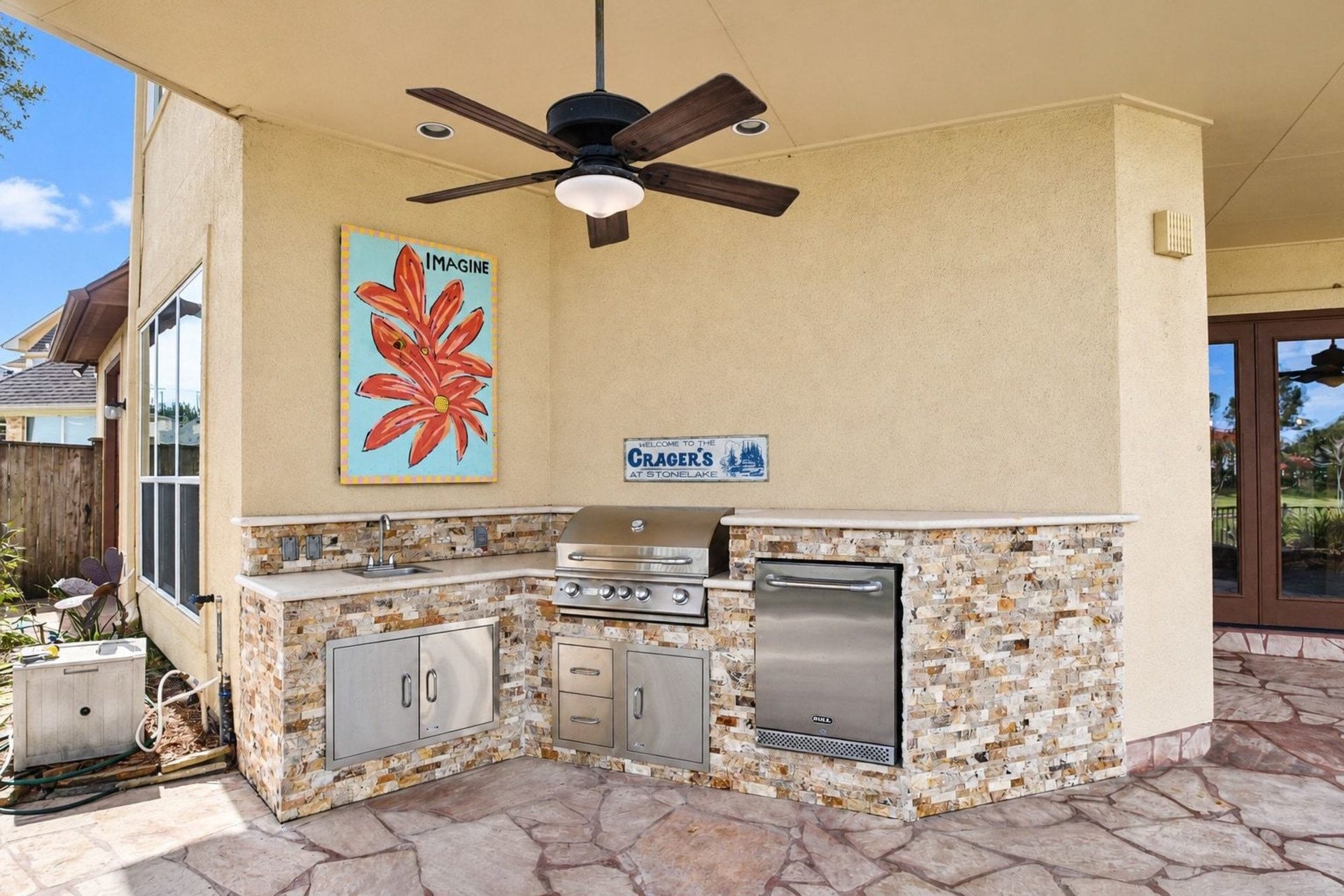5206 Cedar Bend Creek, Houston, TX 77041 This stunning, professional-grade outdoor kitchen serves as the ultimate entertainer's paradise. It features premium high-end appliances, including a top-of-the-line grill, complemented by durable and elegant stone countertops. The space is expertly designed with integrated seating, creating a seamless and inviting atmosphere that is perfect for hosting summer gatherings, alfresco dining, or relaxed evenings with family and friends!