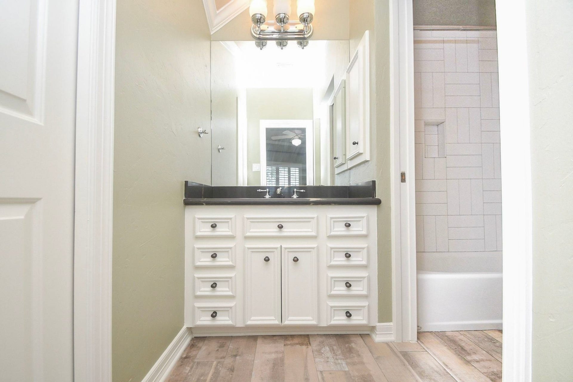 5206 Cedar Bend Creek, Houston, TX 77041 Beautifully upstairs full bathroom featuring a modern vanity, elegant flooring, and a spacious walk-in shower/tub combination with premium finishes!