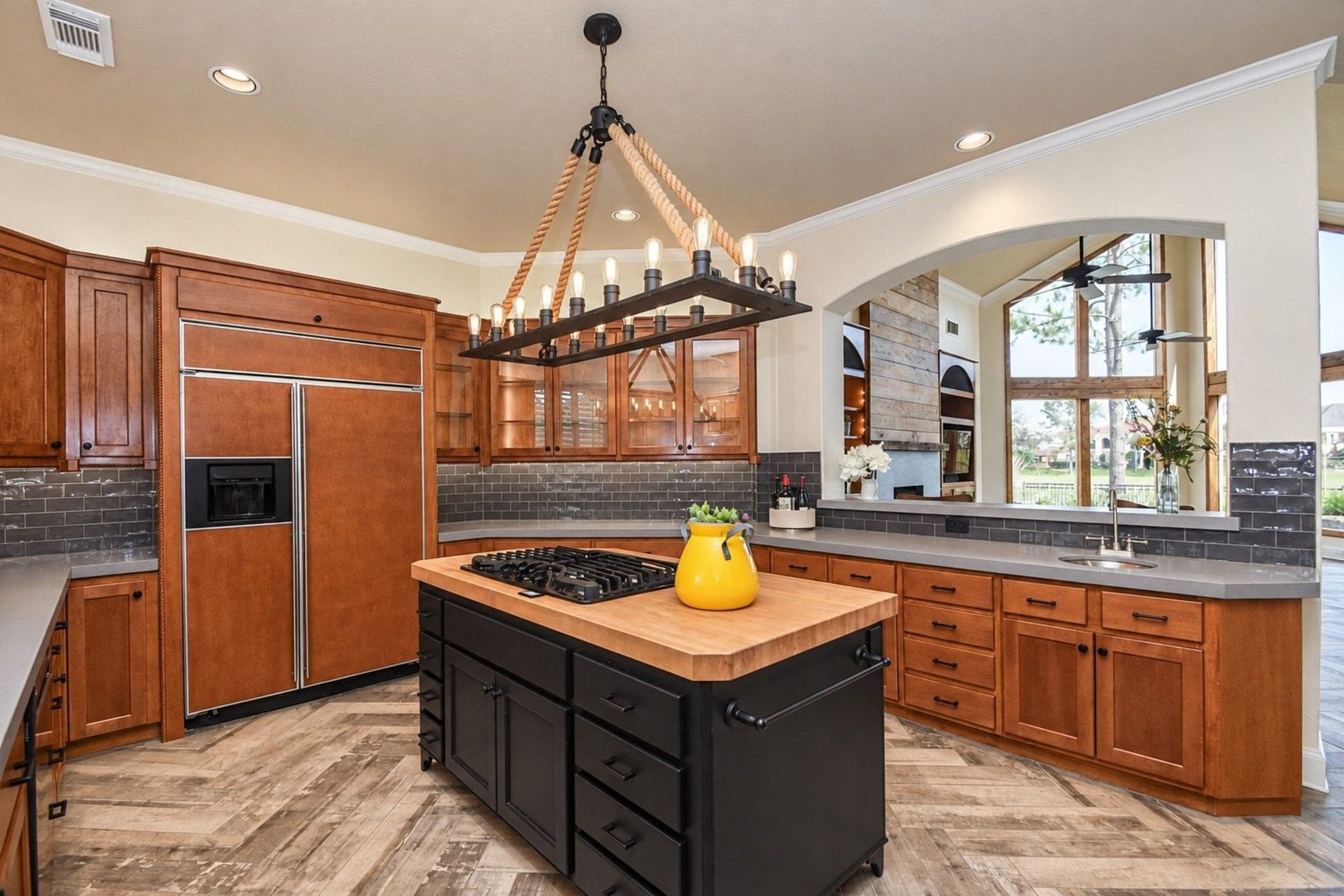 5206 Cedar Bend Creek, Houston, TX 77041 Beautiful kitchen featuring a gourmet cooktop island, perfect for culinary enthusiasts and entertaining. This spacious area offers premium finishes, ample counter space, and a functional layout that serves as the heart of the home!