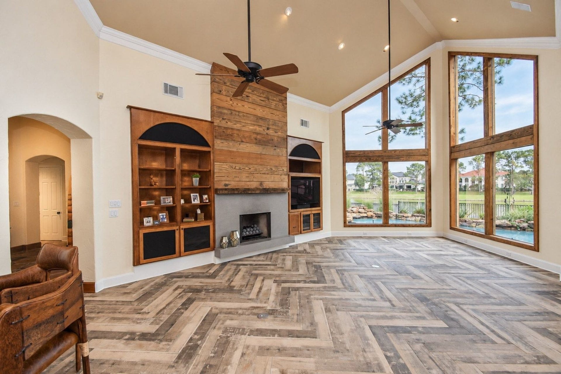 5206 Cedar Bend Creek, Houston, TX 77041 Tons of windows flooding the home with natural light and offering stunning views. The open-concept living space is perfect for entertaining and features high-end custom built-ins, complemented by a cozy gas fireplace that serves as a beautiful centerpiece!