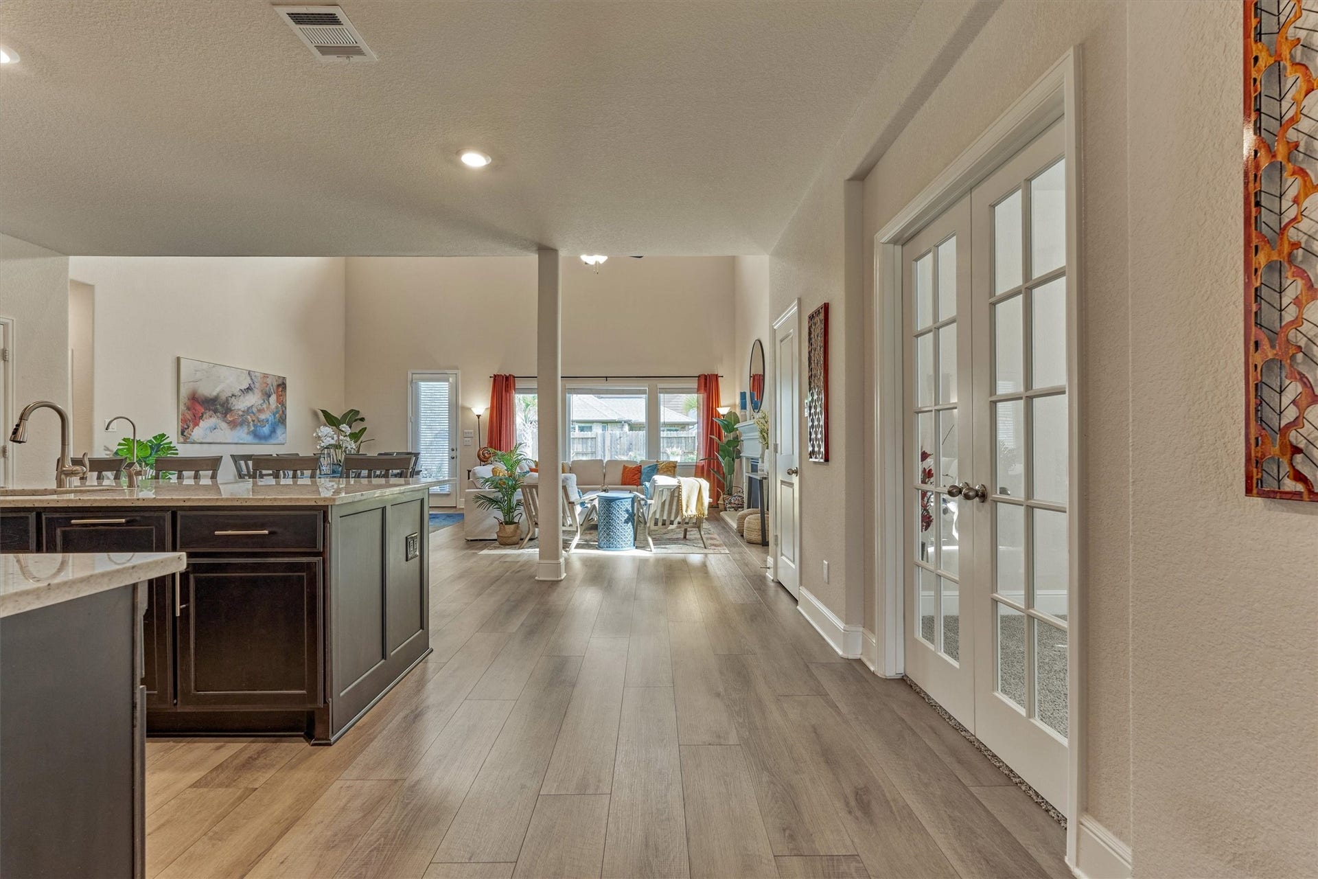 The view from the entry looks over the main living areas and the pool.