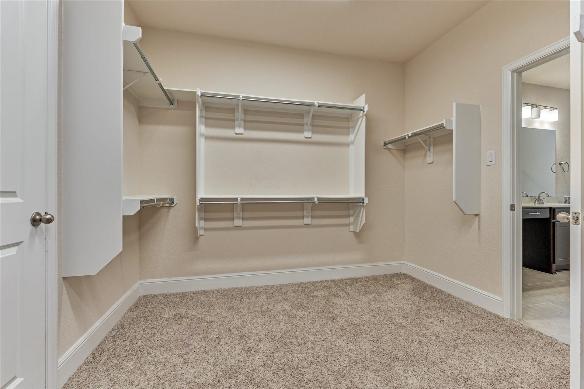Main bedroom closet that leads to the laundry room.