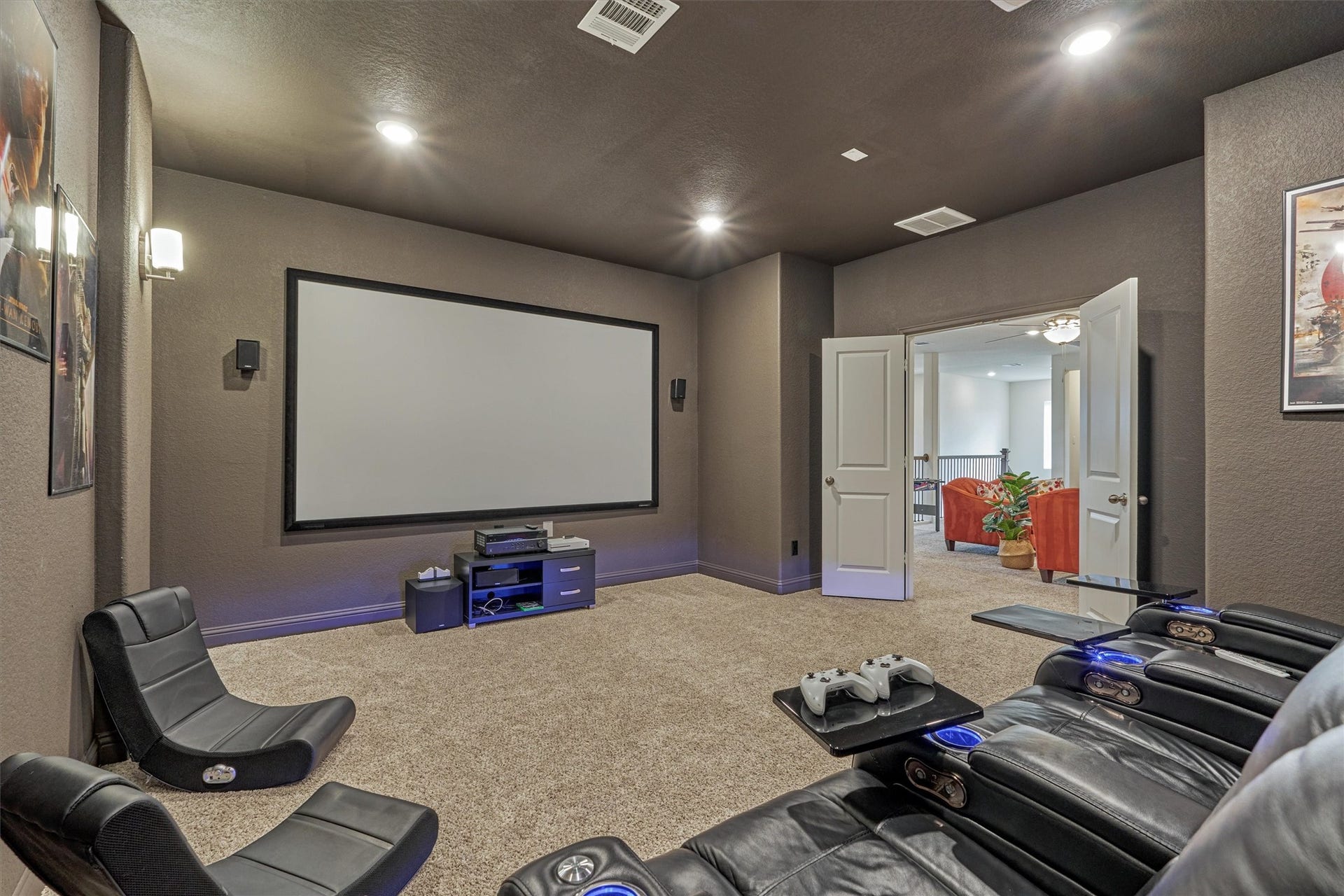 The media room is the perfect place to watch your favorite movie. The media equipment stays.