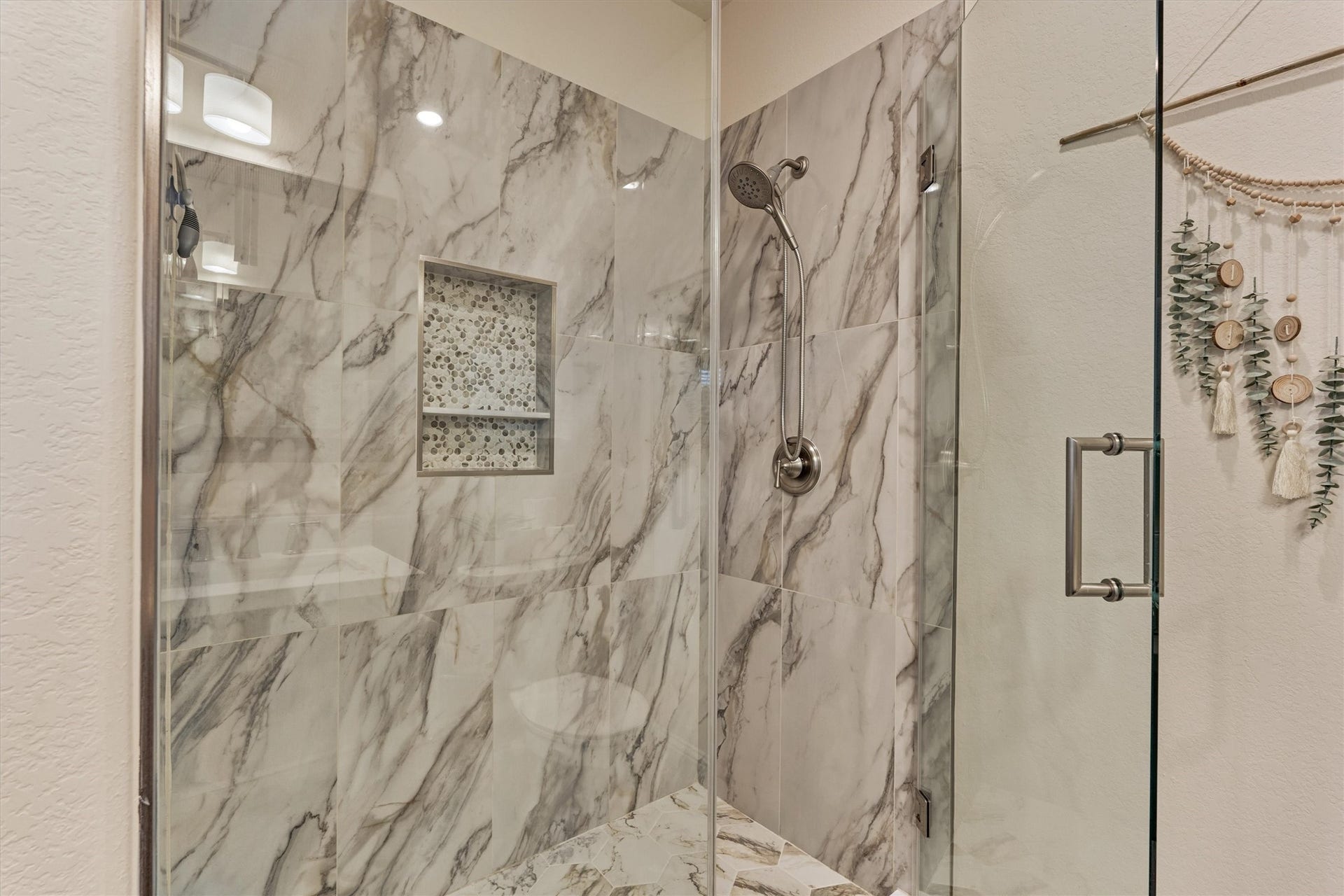 The shower is connected to the first of the three secondary bedrooms upstairs. This would make the best second primary suite.