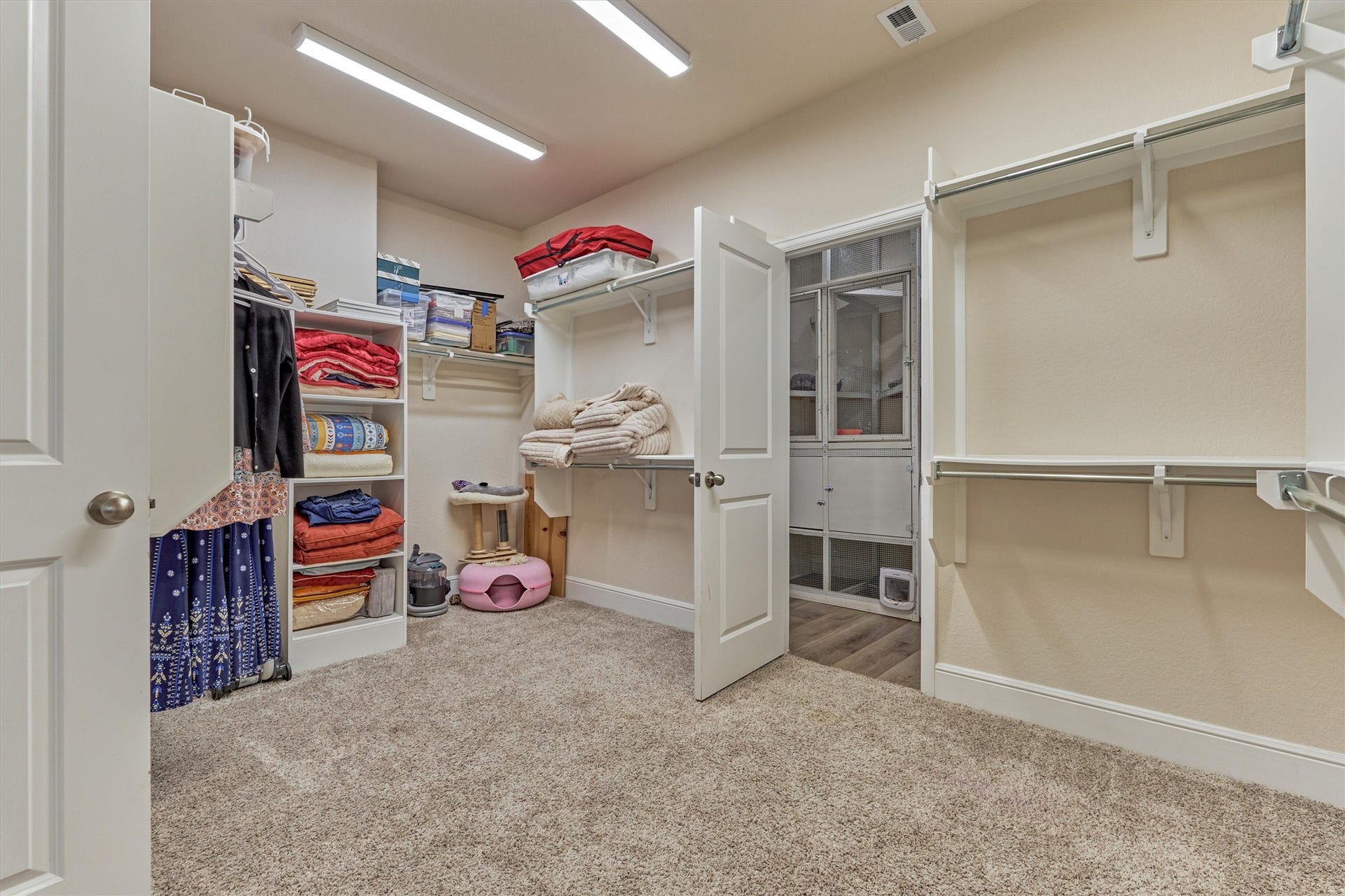 Main bedroom closet that leads to the laundry room.