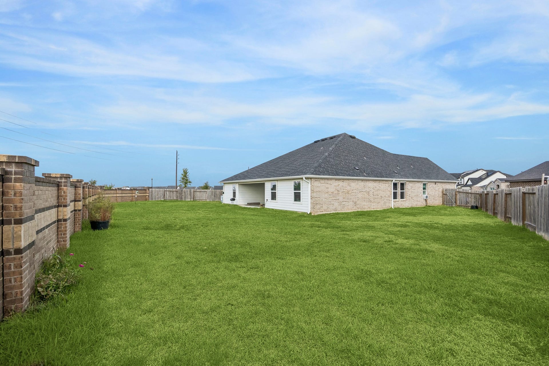 3938 Hordley Terrace Trail, Fulshear, TX 77441 Large backyard with plenty of open green space, no back neighbors, and a brick fence along the rear for added privacy.