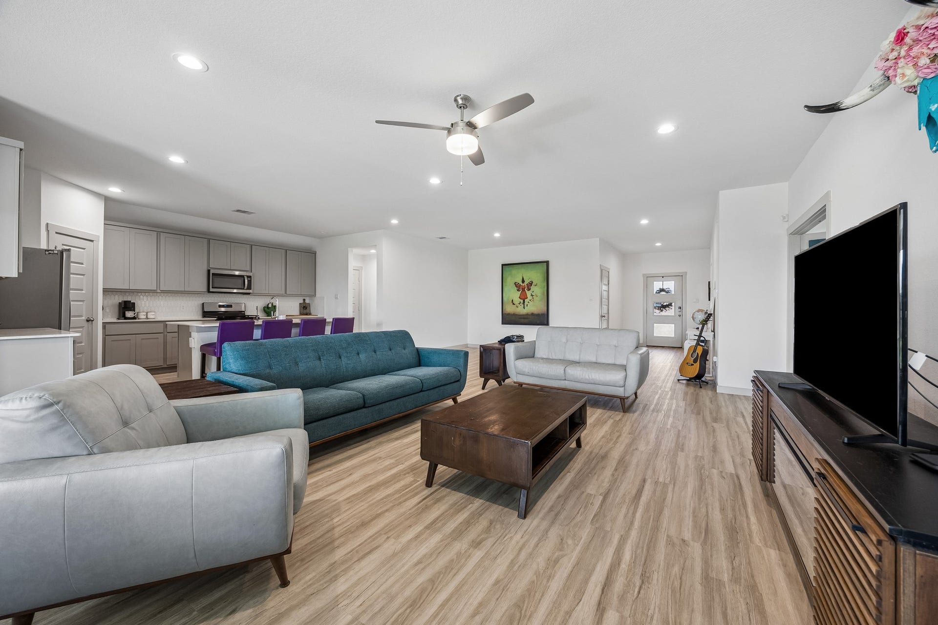 3938 Hordley Terrace Trail, Fulshear, TX 77441 High ceilings add to the open, spacious feel, while easy-care vinyl plank flooring runs throughout the main living area for a clean, low-maintenance finish.