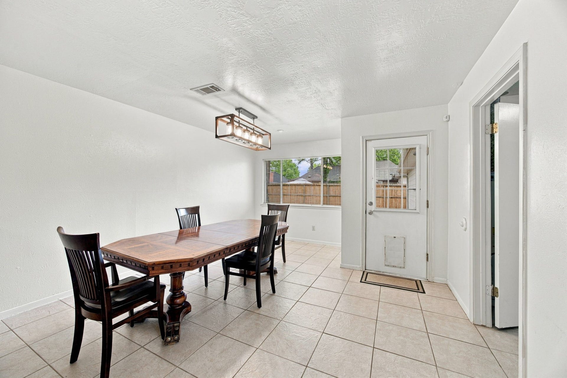 8902 Rocky Lane, Houston, TX 77040 This large dining room has room for all your furniture. Laundry is the right and the back door leads to the yard and detached 3 car garage.