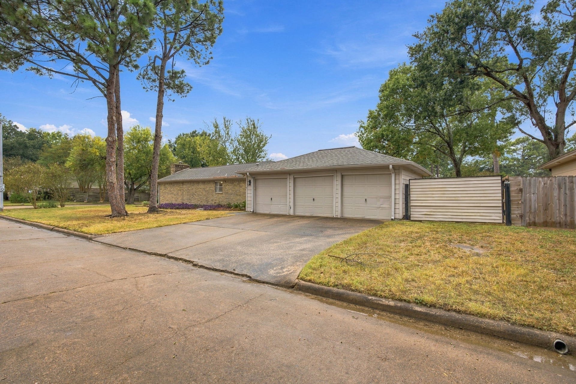8902 Rocky Lane, Houston, TX 77040 Three car garage with additional parking to the side. Perfect for the mechanic of the family or a small trailer.