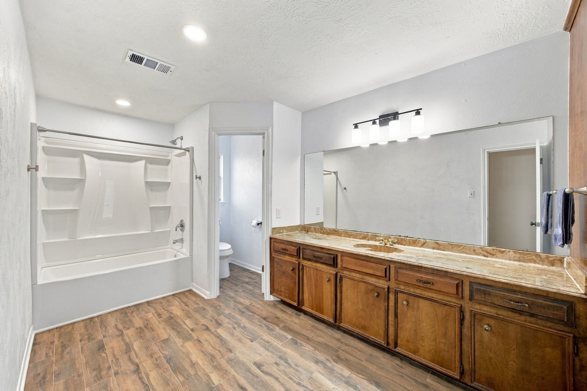 8902 Rocky Lane, Houston, TX 77040 This guest bathroom is very large. It has plenty of room for future expension of the shower or even more cabinetry.