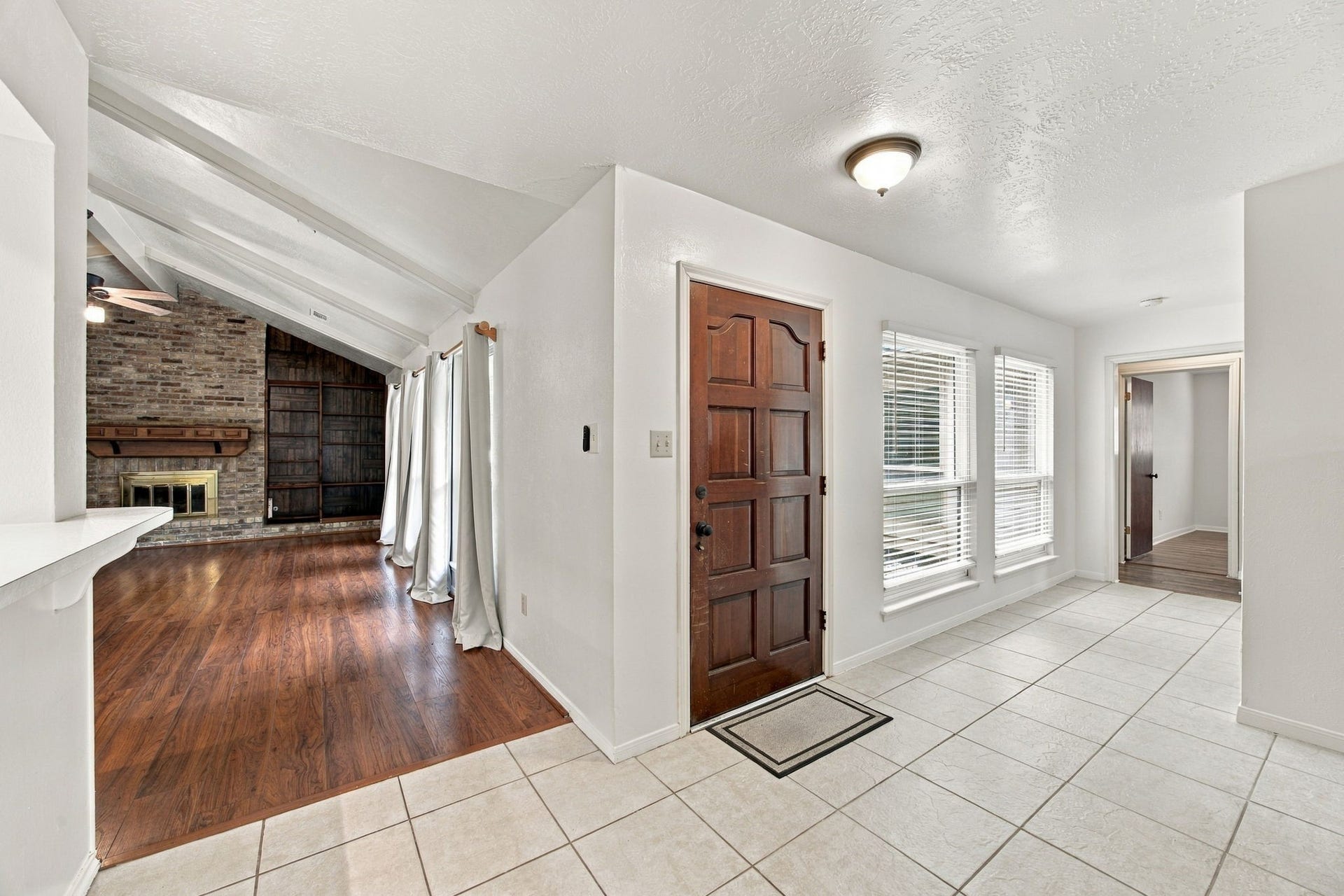 8902 Rocky Lane, Houston, TX 77040 You enter in the middle of the home. To the left (in this picture) is the living room ahead and the kitchen to the left. Bedrooms are to the right. Dining room and laundry room are behind.