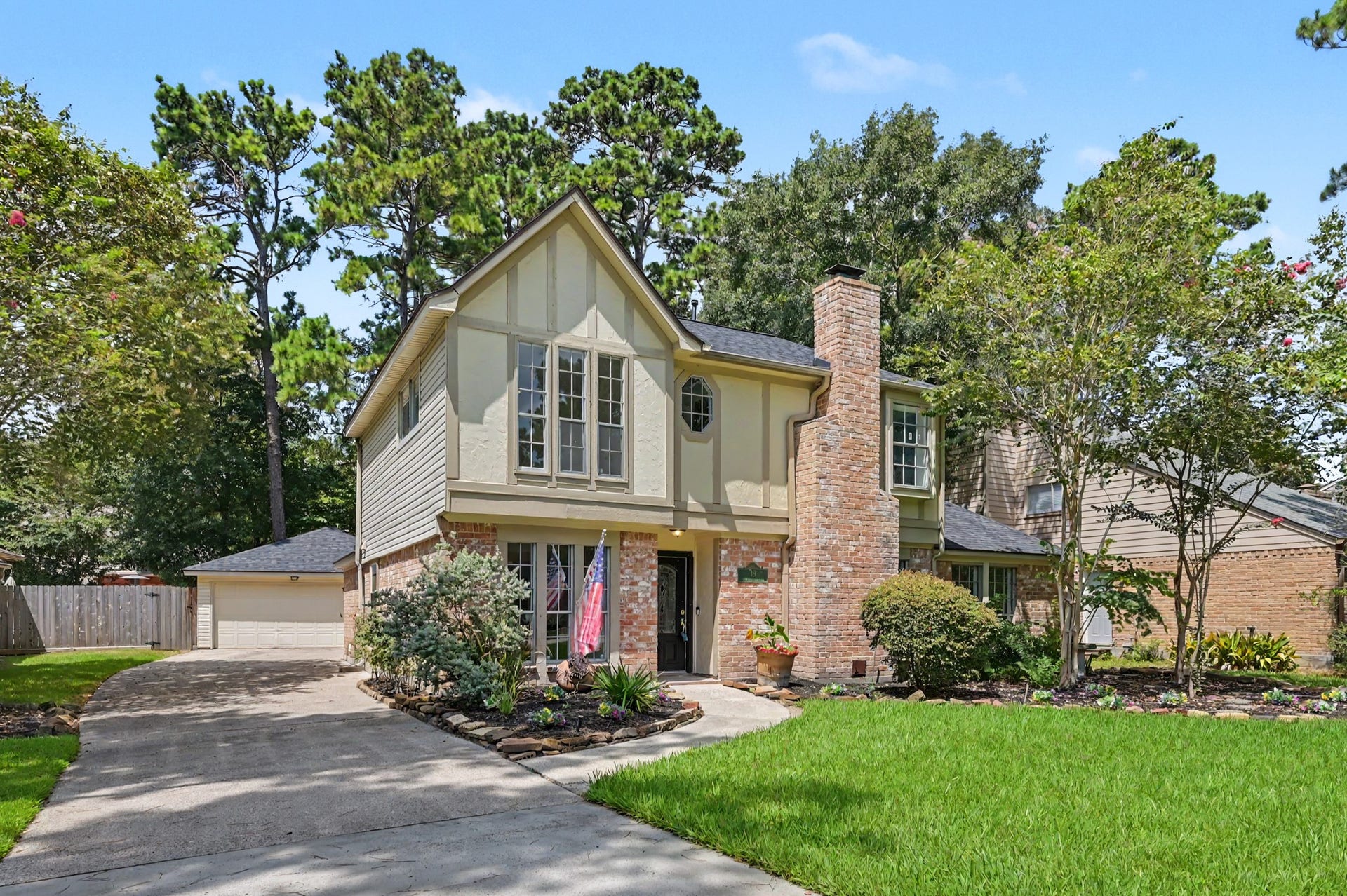 19 Postvine Court, The Woodlands, TX 77381 Charming 2 story home is nestled among mature trees located on a cul-de-sac. This property features tudor-style accents, large lot, spacious driveway , & a welcoming path leading to the front door.