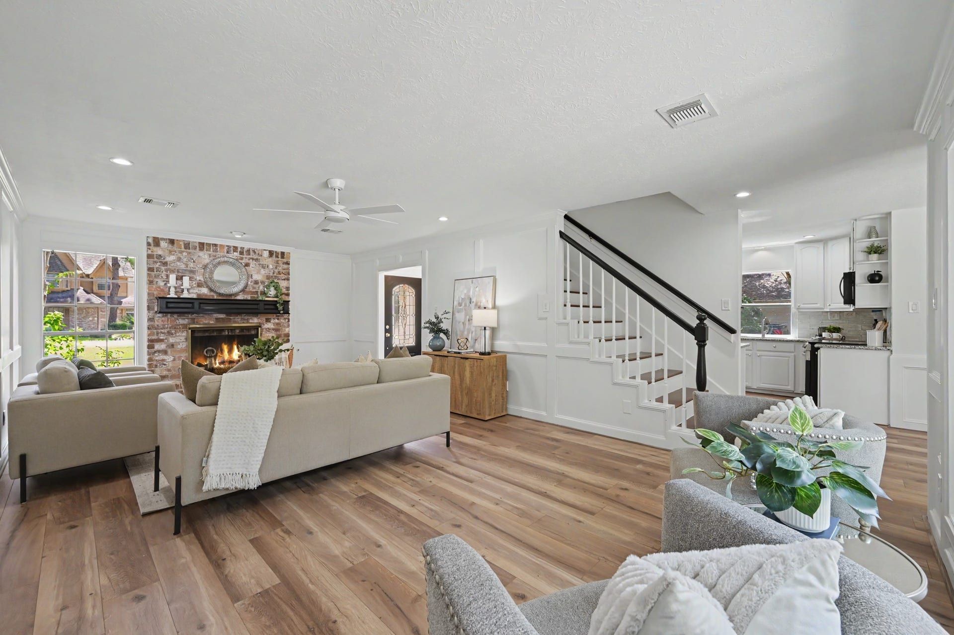 19 Postvine Court, The Woodlands, TX 77381 The living area features a brick fireplace, NEW vinyl flooring, fresh paint, & elegant wainscoting.