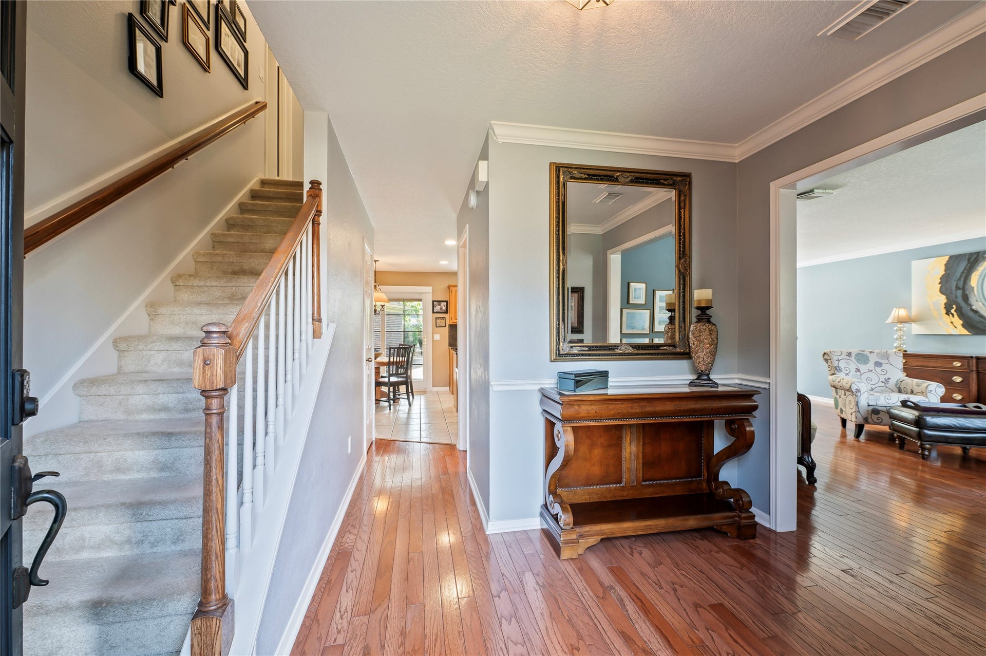 113 Coral Bay Drive, League City, TX 77573 The foyer opens to the formal living room on the right, with crown molding and chair rail throughout.