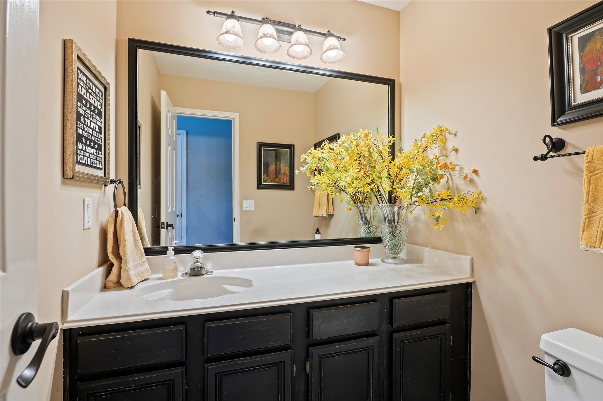 113 Coral Bay Drive, League City, TX 77573 The larger-than-normal half bath downstairs has extra cabinet space and storage.