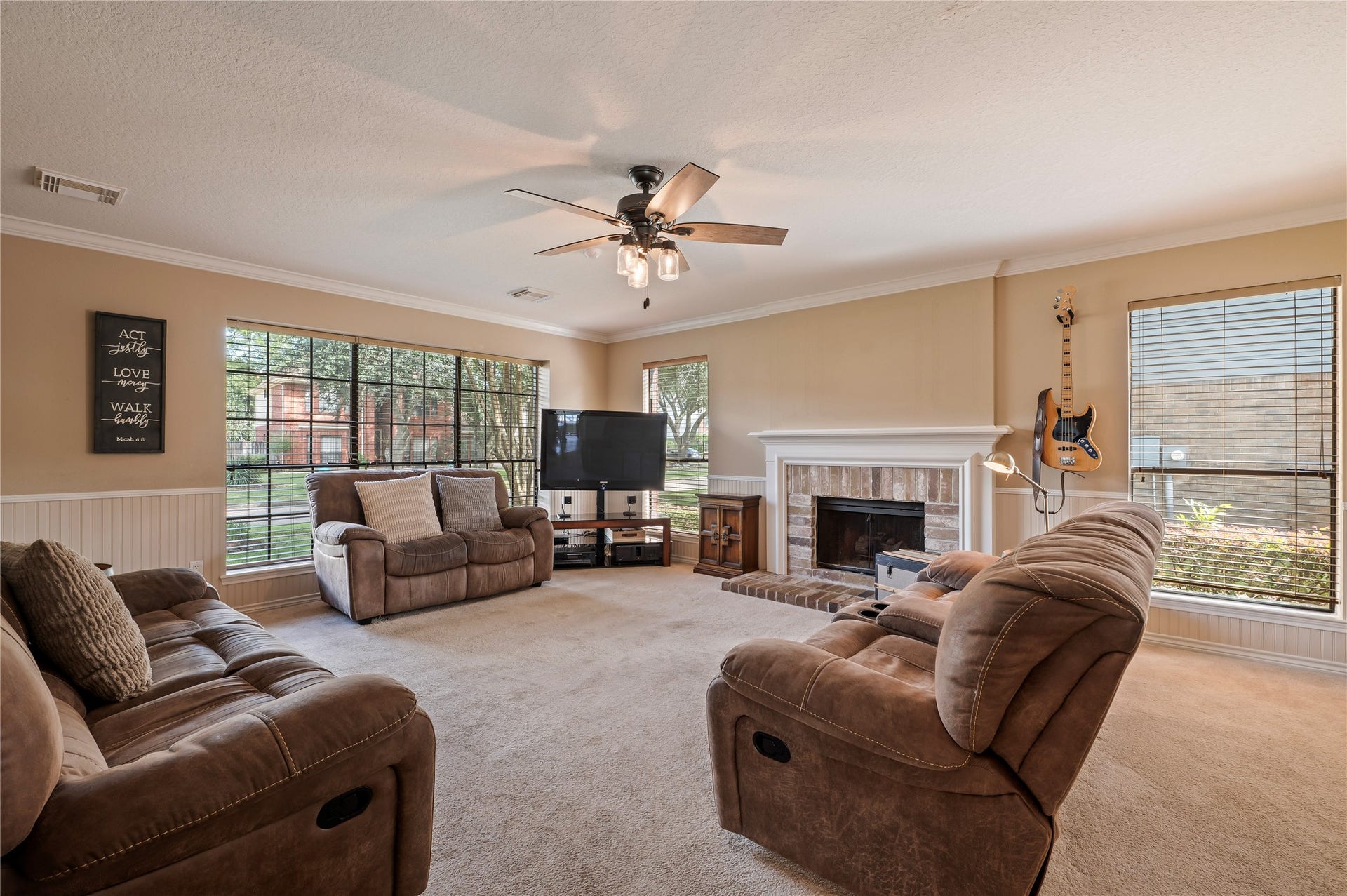 113 Coral Bay Drive, League City, TX 77573 The family room is right off the kitchen with a fireplace, bead board and a wall of windows.