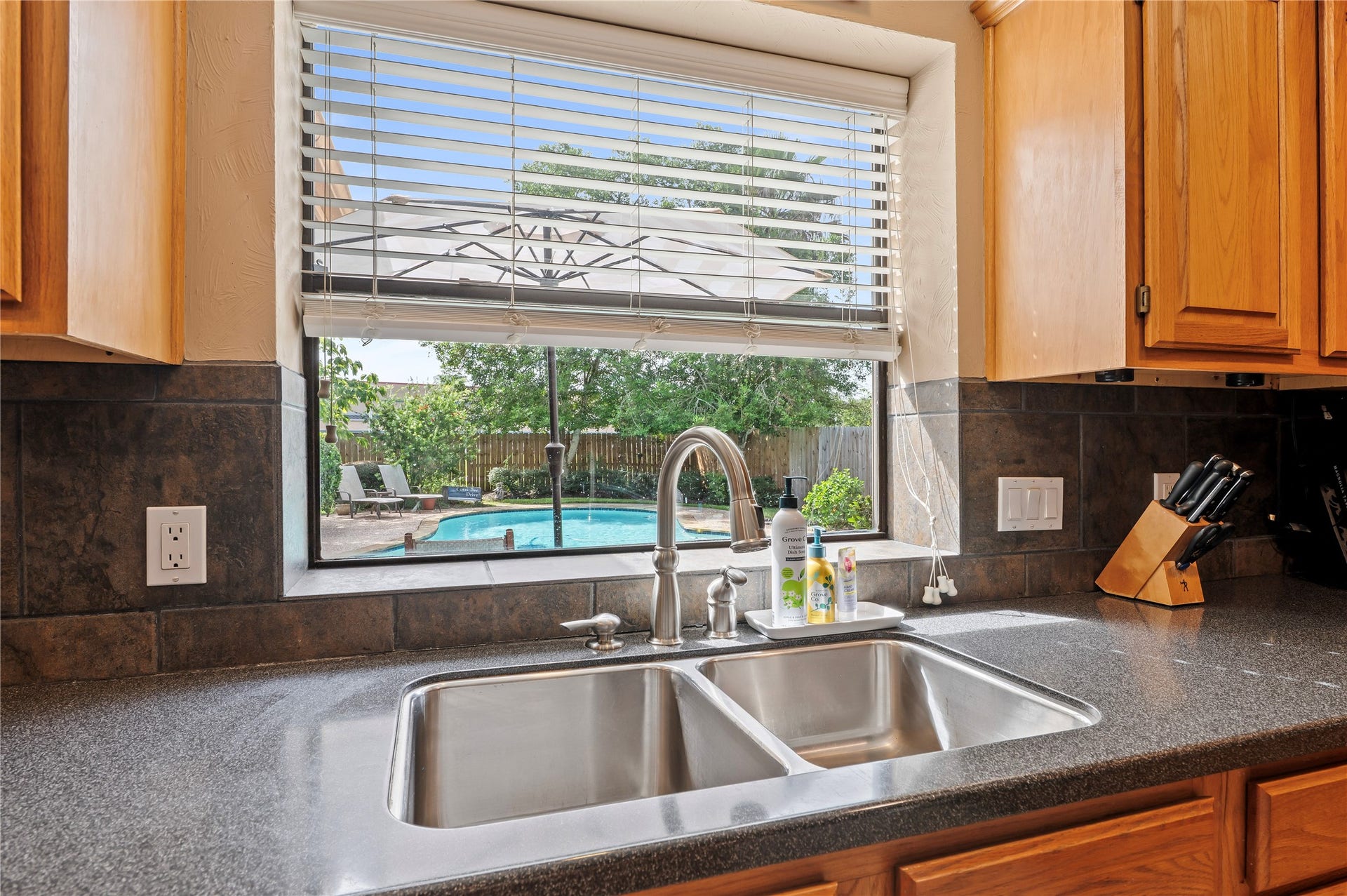 113 Coral Bay Drive, League City, TX 77573 Taking care of dishes while planning for the next pool party.