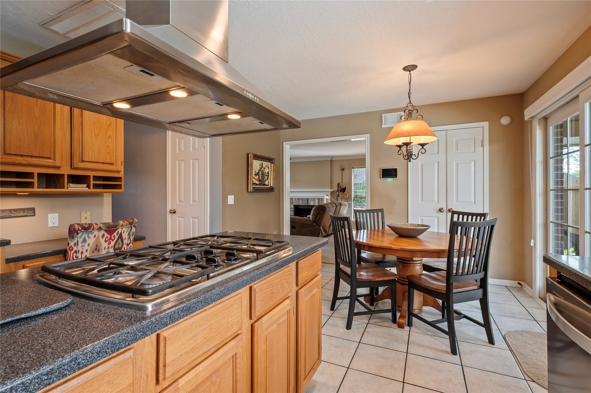 113 Coral Bay Drive, League City, TX 77573 The 4-burner gas cooktop on the island looks right out to the breakfast are with plenty of space in the kitchen.