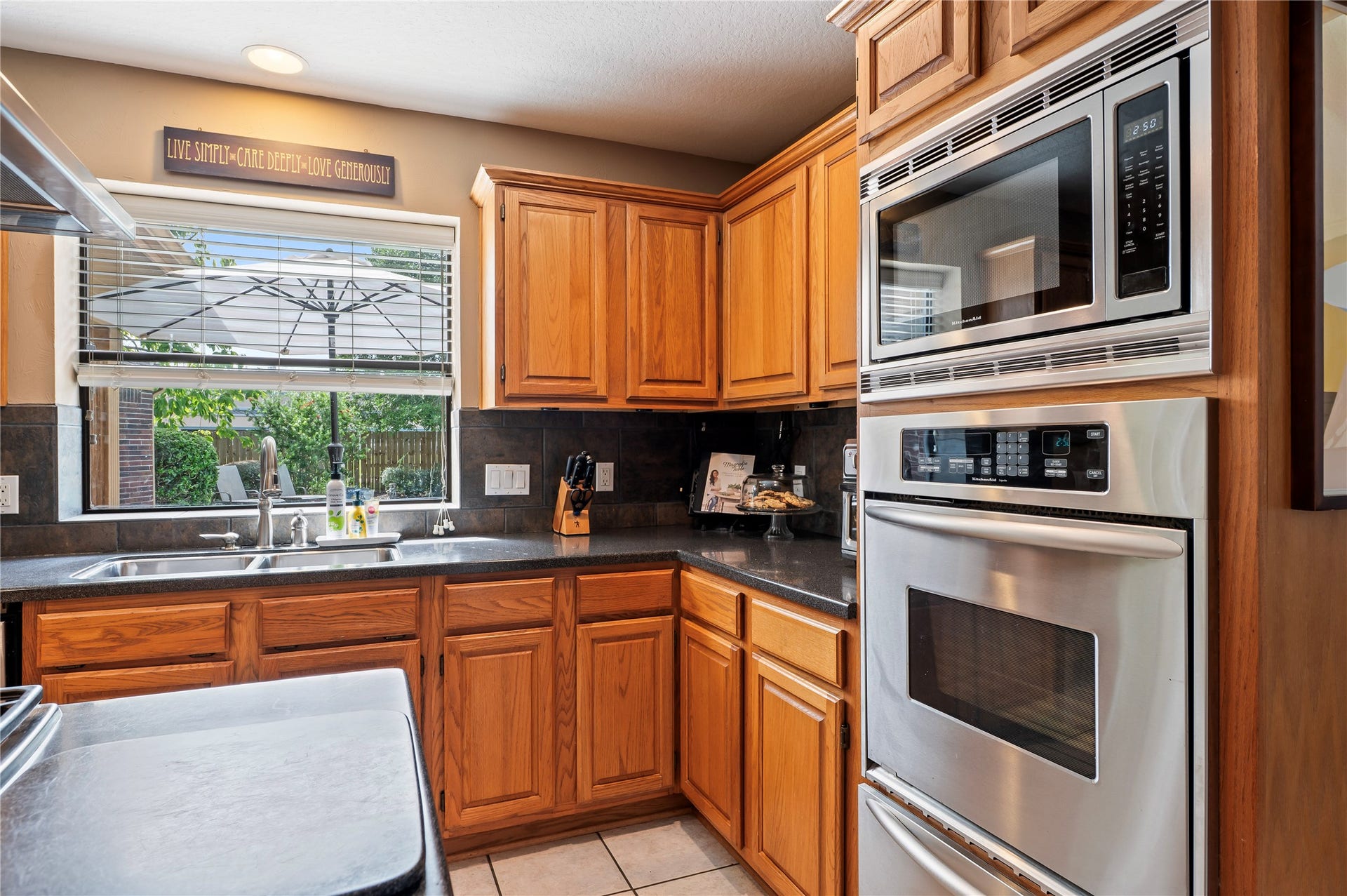 113 Coral Bay Drive, League City, TX 77573 Built-in microwave, wall oven and a warming oven, plus a slate backsplash and under-cabinet lighting.