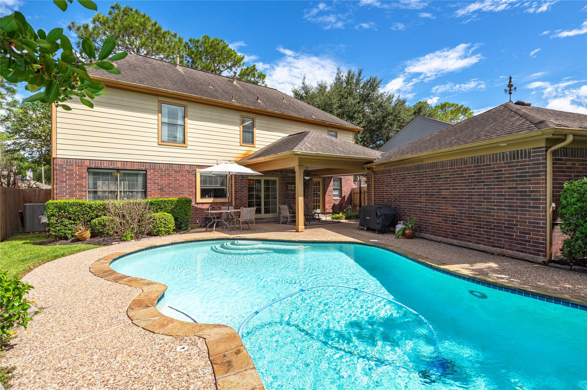 113 Coral Bay Drive, League City, TX 77573 Gorgeous view of the back of the home with Hardie board siding and a sparkling pool.