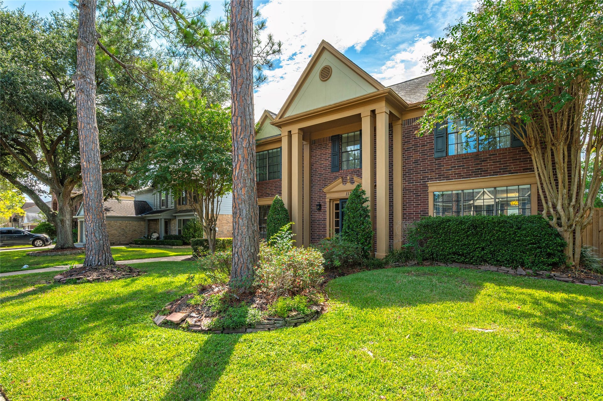 113 Coral Bay Drive, League City, TX 77573 Landscaped beds around the mature trees give the front a true estate feel.
