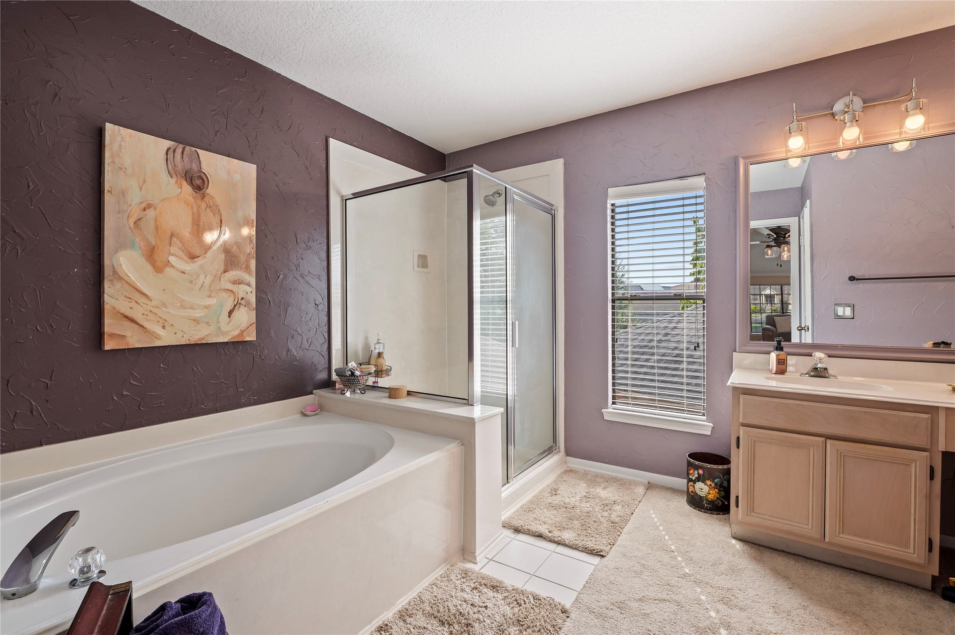 113 Coral Bay Drive, League City, TX 77573 The primary bath has a garden tub and a separate glass-enclosed shower.