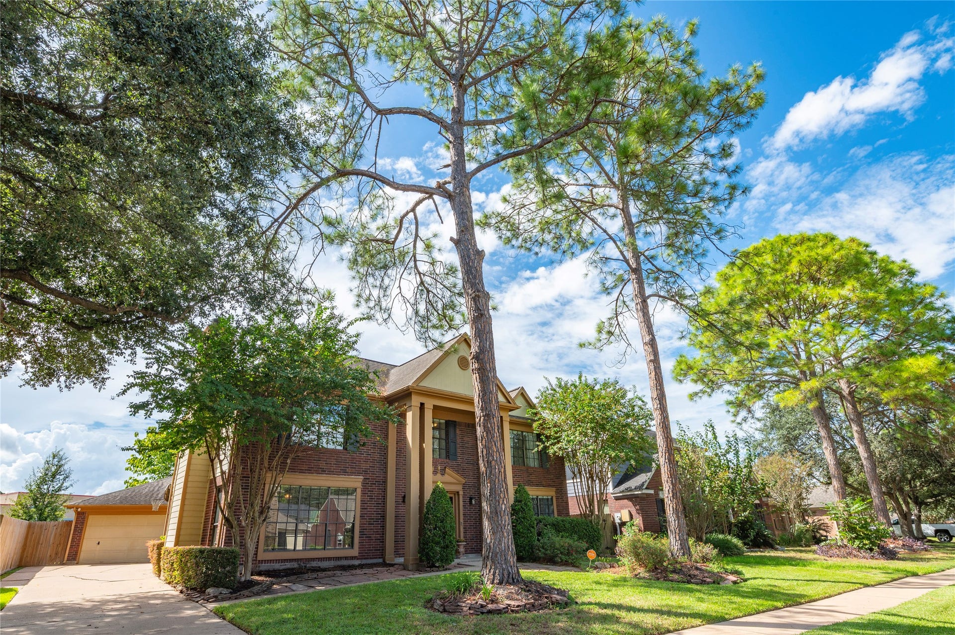 113 Coral Bay Drive, League City, TX 77573 Towering pines and mature shade trees frame the home beautifully.